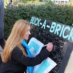 Student participating in Buck-A-Brick